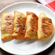 Keto empanadas are served on a white plate with a napkin.