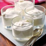 Ricotta dessert is served in glass cups with spoons.