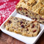 Keto fruit cake, sliced, is served on a white tray.