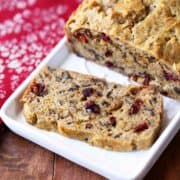 Keto fruit cake, sliced, is served on a white tray.