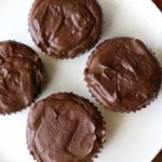 Mini chocolate cheesecakes are served on a white plate.