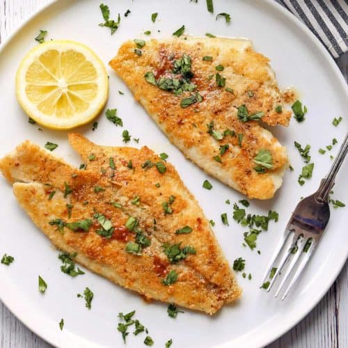 Sole meunière is served on a plate with a fork.