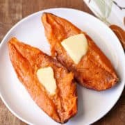 Microwave sweet potato is topped with butter.