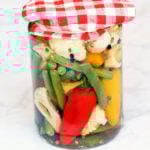 Quick pickles are stored in a glass jar.