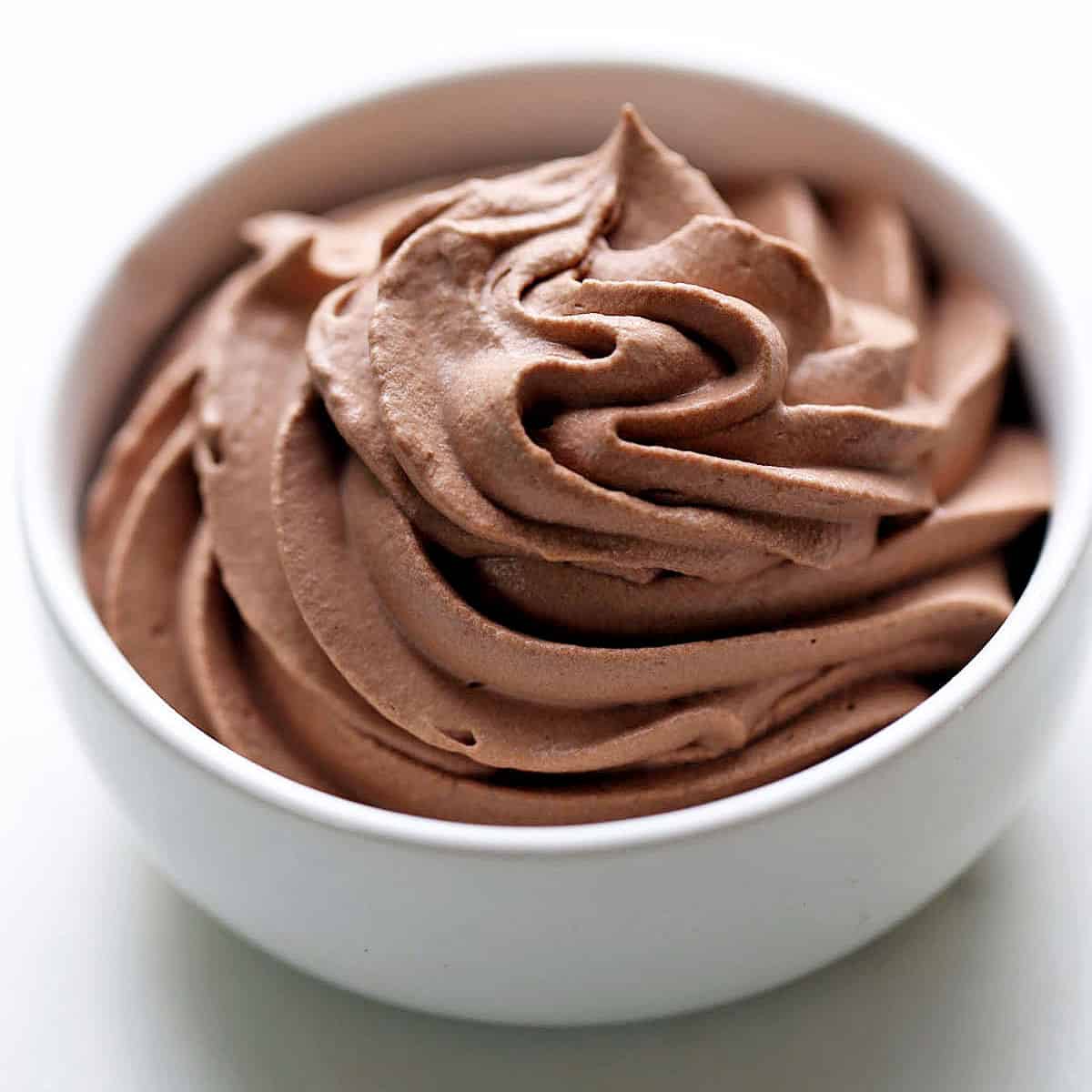 Keto chocolate whipped cream is served in a white bowl.