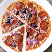 Crustless pizza is served on a white plate.