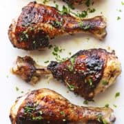 Jerk chicken is served on a white plate.