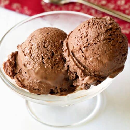 Chocolate frozen yogurt is served in a glass dessert cup.