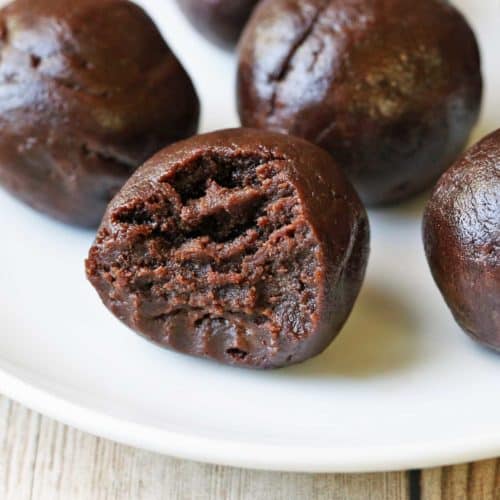 Keto fat bombs are served on a white plate.