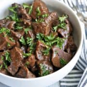 Beef heart stew is served in a bowl with a napkin.