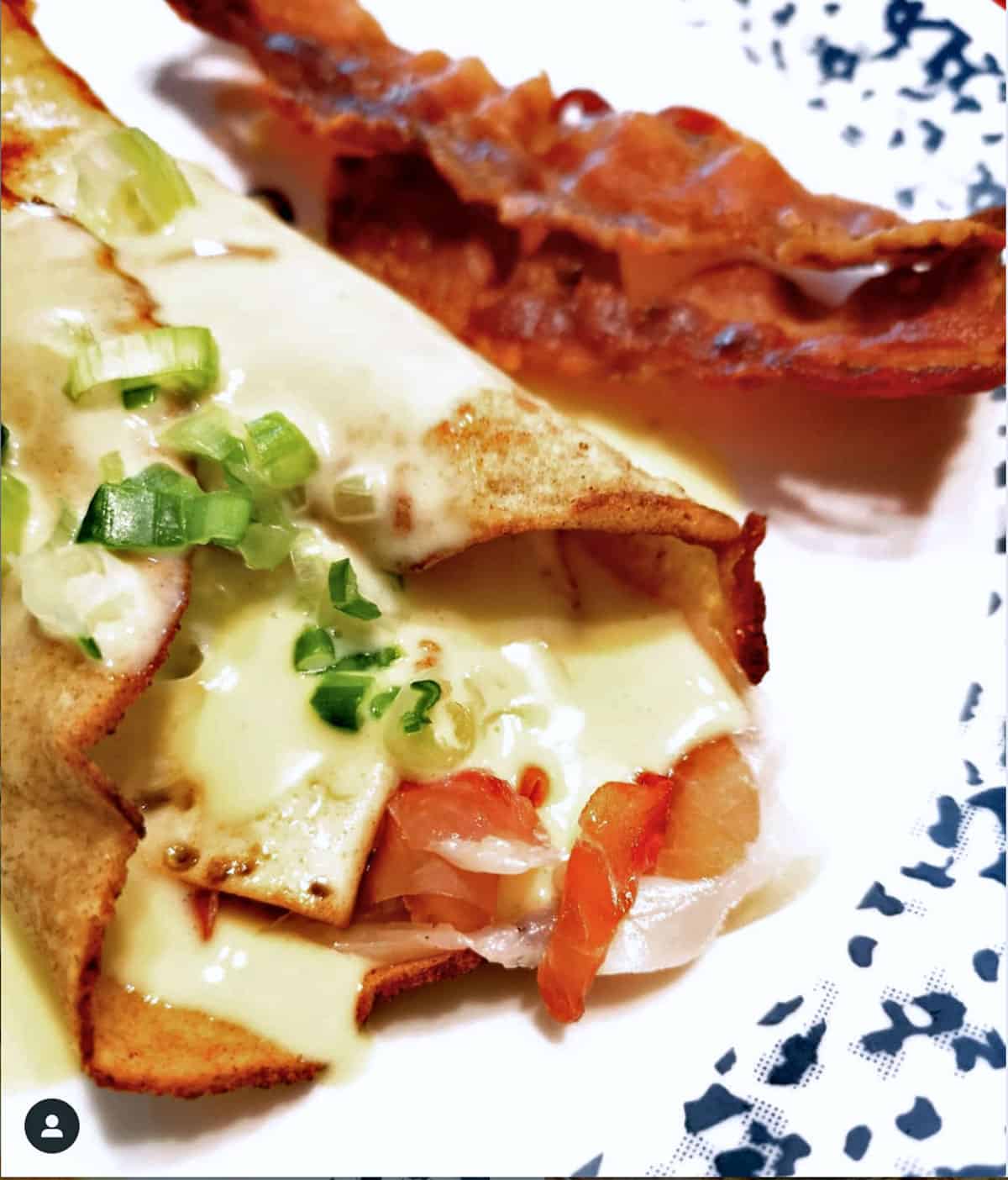 Savory keto crepes with prosciutto, fried egg, and hollandaise sauce. 