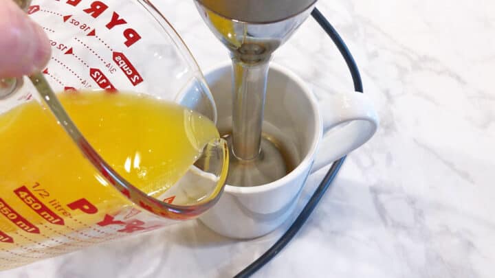 Pouring hot melted butter into the cup.