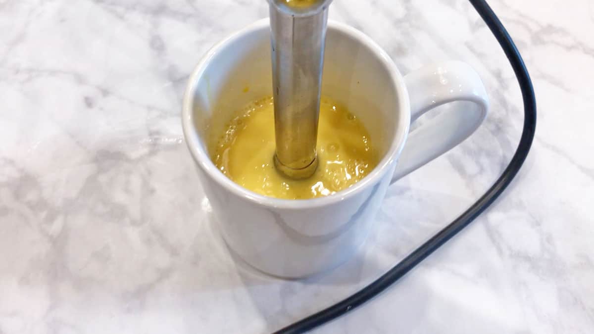 Blending hollandaise sauce with an immersion belnder. 