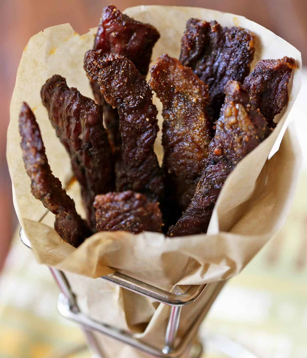 Keto beef jerky is served in a parchment paper cone. 