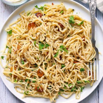 Hearts of palm pasta is served on a white plate with a fork.