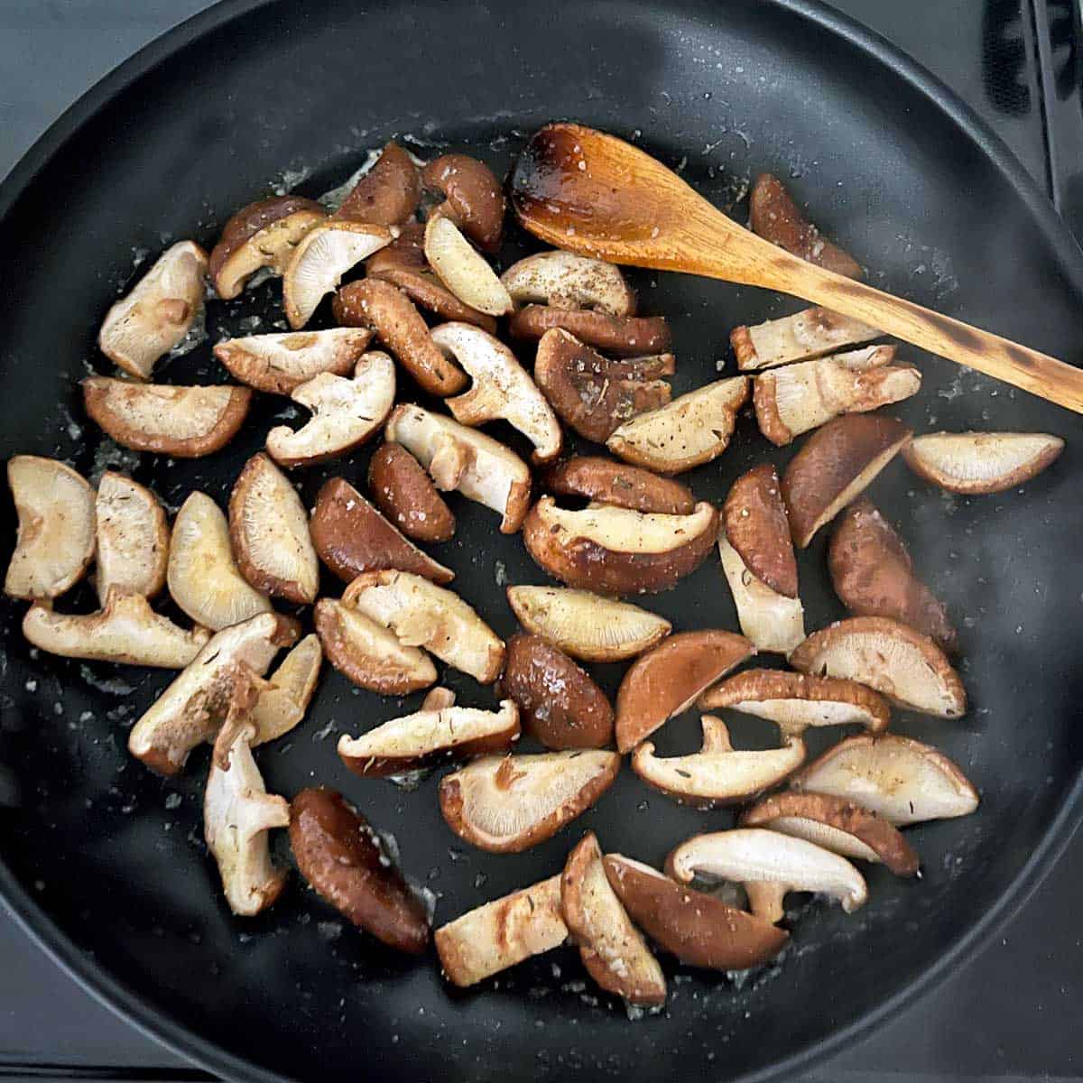 Cooking the mushrooms in a skillet. 