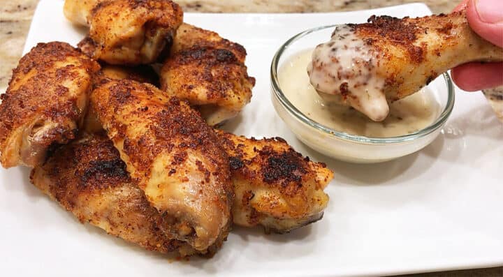 The wings are served with a dipping sauce.