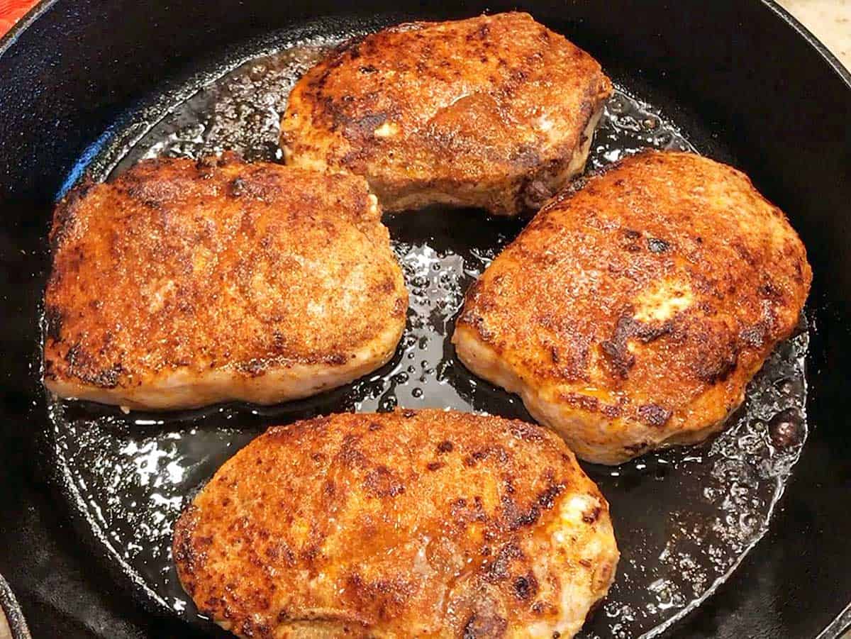 The pork chops were removed from the oven and are ready to be served.