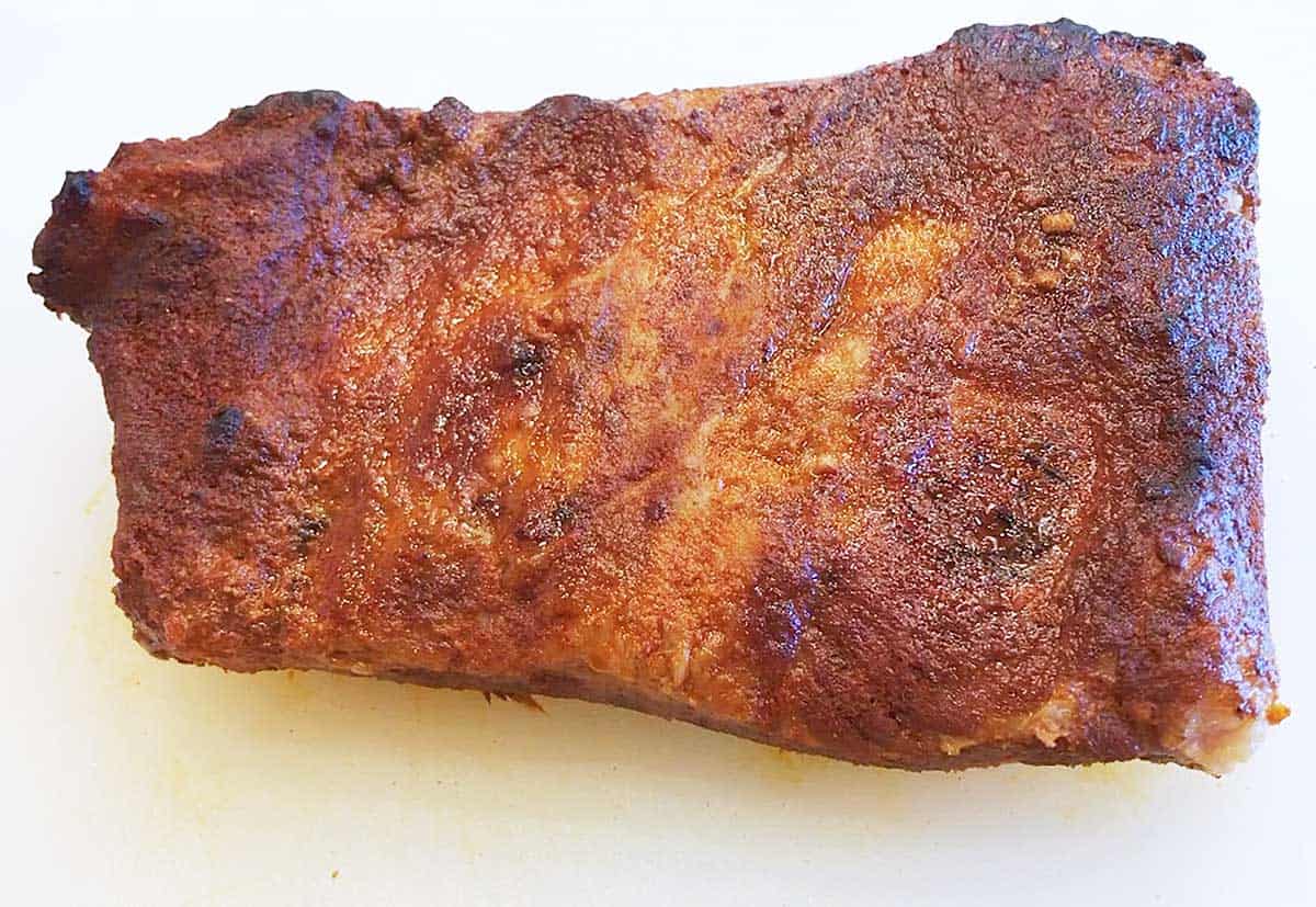 Fully cooked oven brisket in a cutting board. 