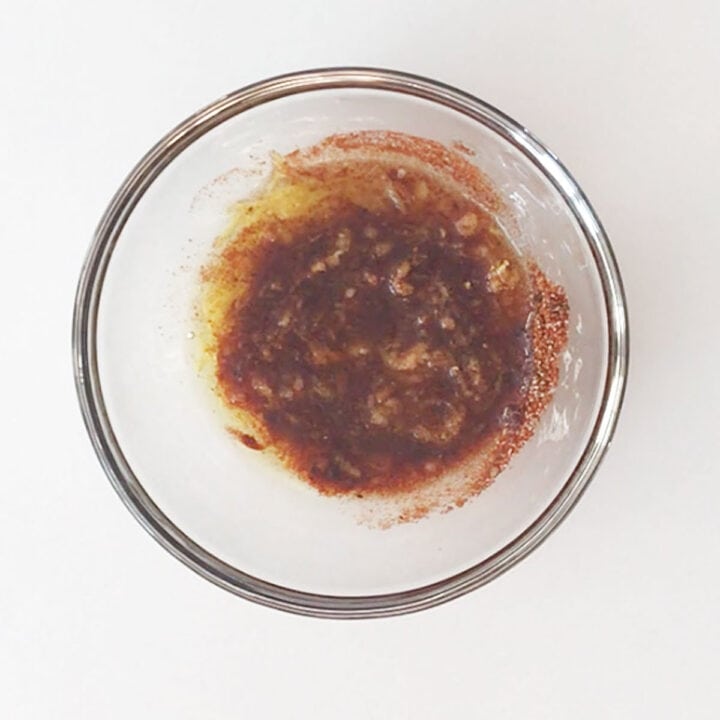 A mixture of olive oil and spices in a bowl.