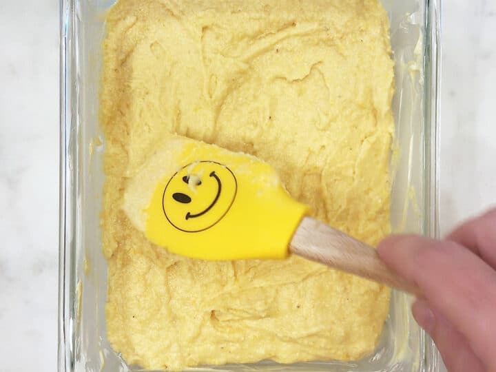 Smoothing out the top of the batter in the pan.