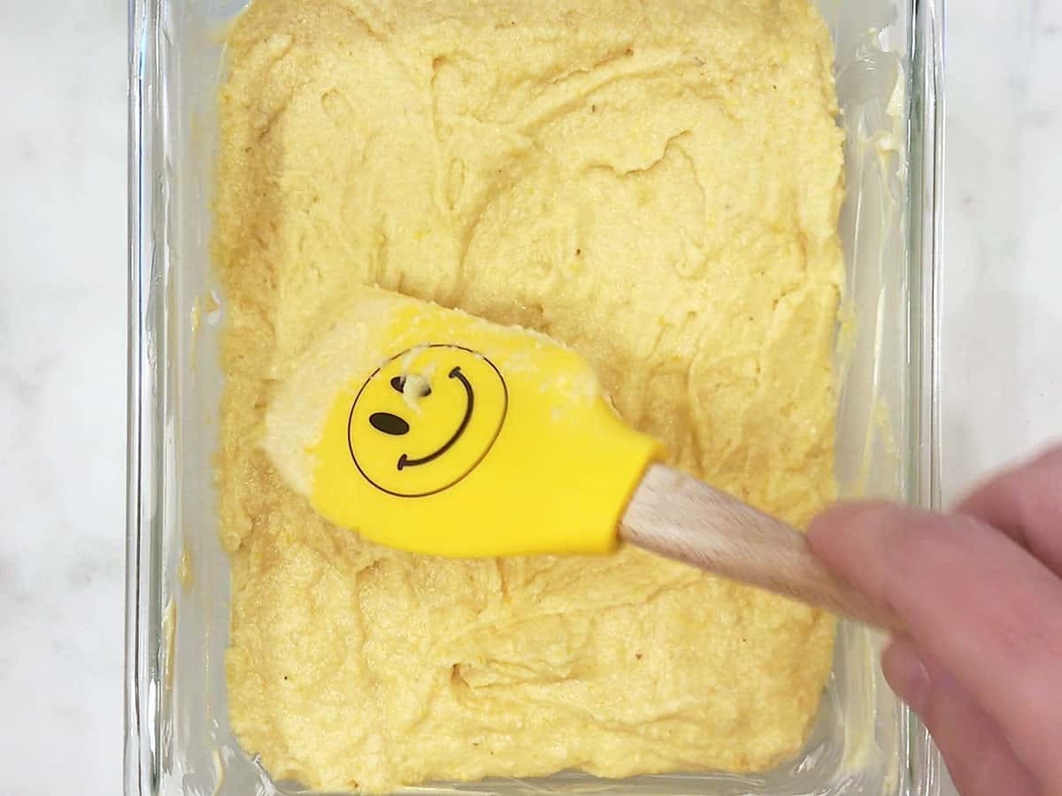 Smoothing the top of the batter with a spatula. 