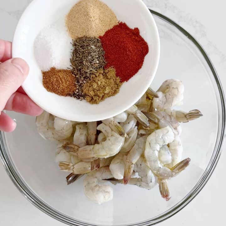 Adding spices to the shrimp.