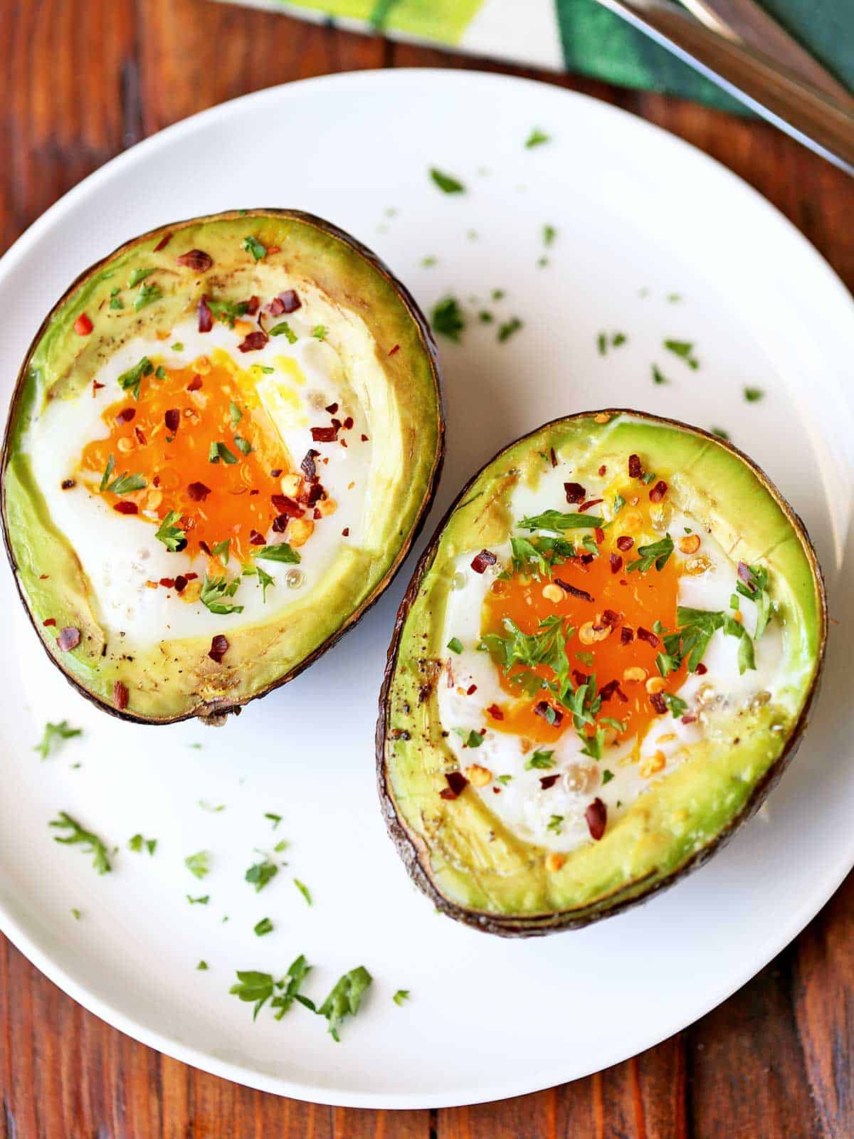 Avocado egg bake on a white plate.