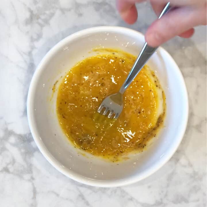 Mixing egg and spices in a bowl.