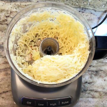 Shredding potatoes in the food processor.