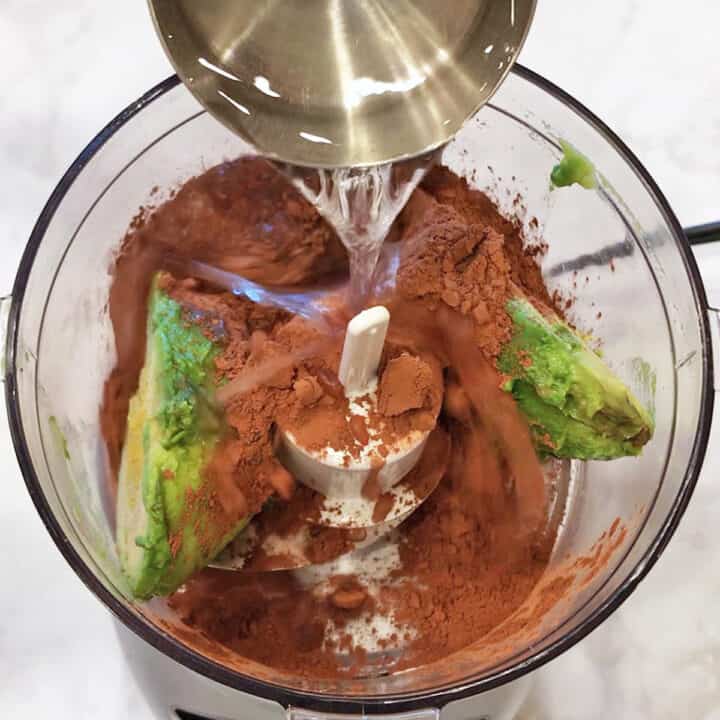 Adding water to the food processor.