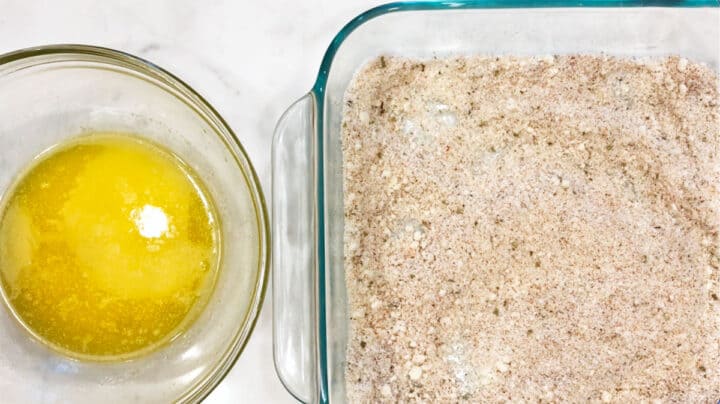 A container with seasoned parmesan and a container with melted butter.