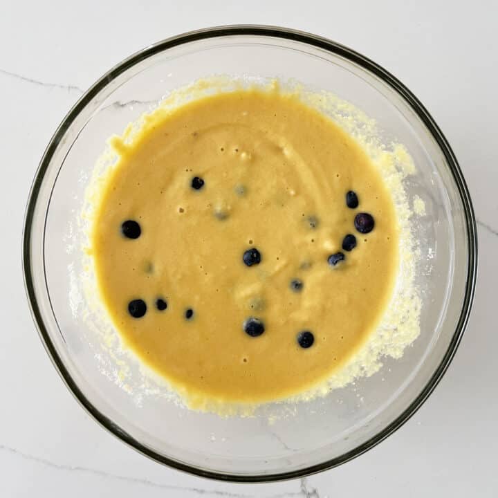 Adding blueberries to the batter.