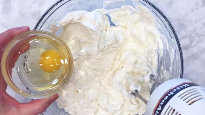 Adding eggs.