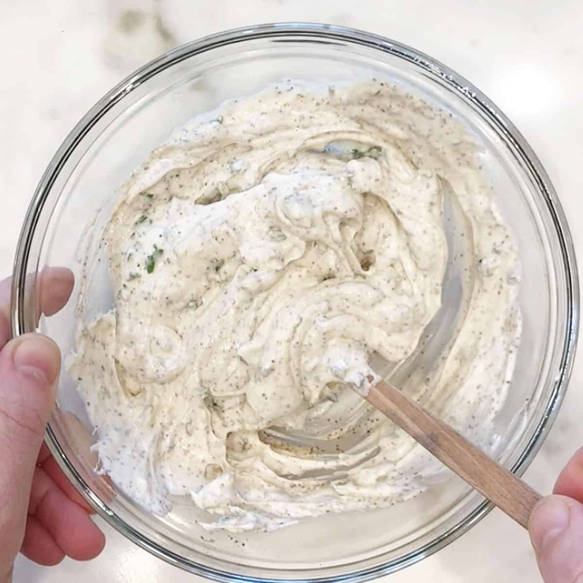 Mixing the dip ingredients in a bowl.