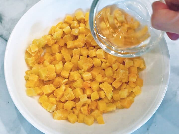 Adding water to the bowl with the squash.
