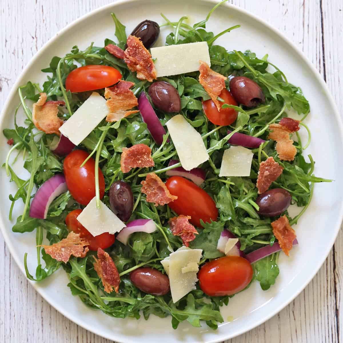 Arugula salad with added bacon.
