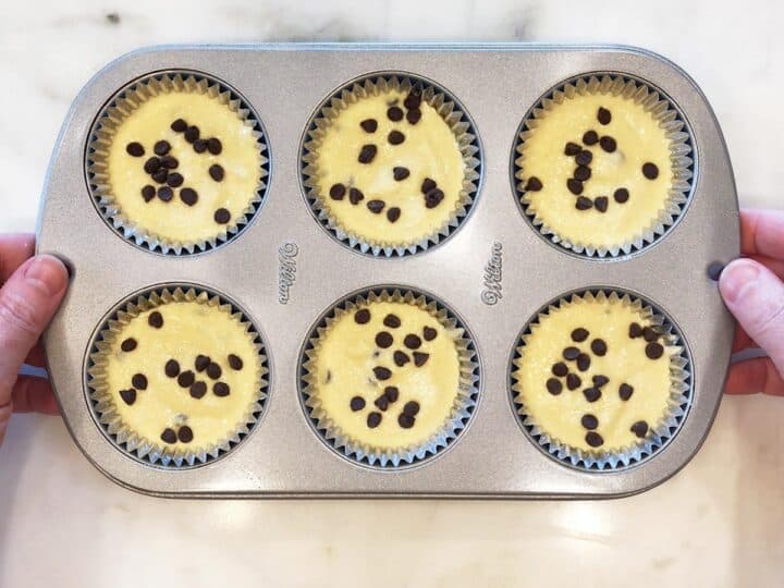 The batter was divided between muffin cups.