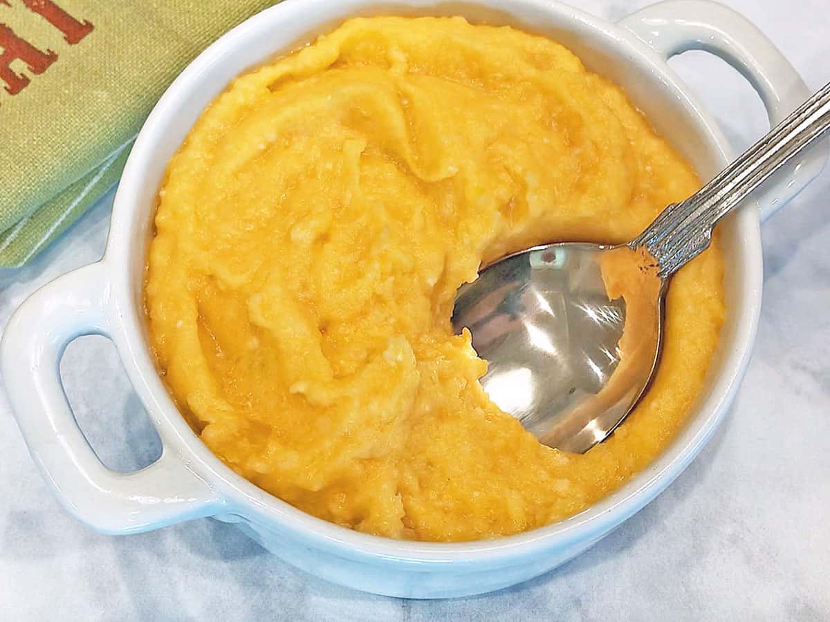 The mash is served in a white bowl.