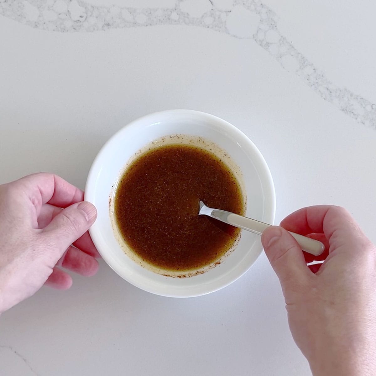 Mixing the marinade in a small bowl.