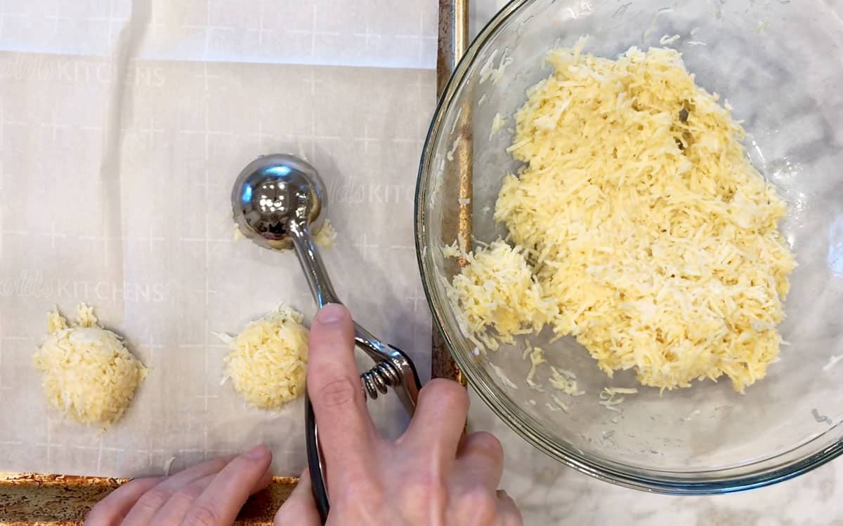 Placing mounds of the mixture on the baking sheet.