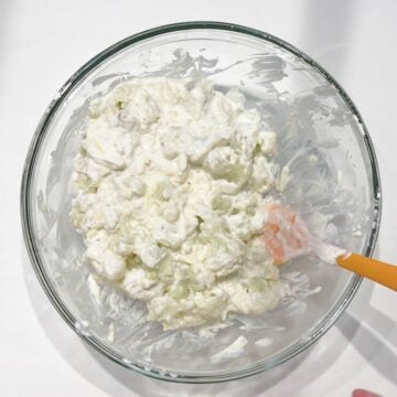 Coating the cauliflower in the sauce.