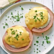 Keto Eggs Benedict is served on a white plate with a napkin.