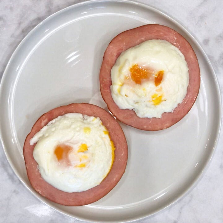 Topping the dish with poached eggs.