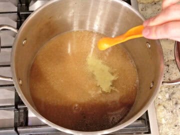 Broth and spices in a stockpot.