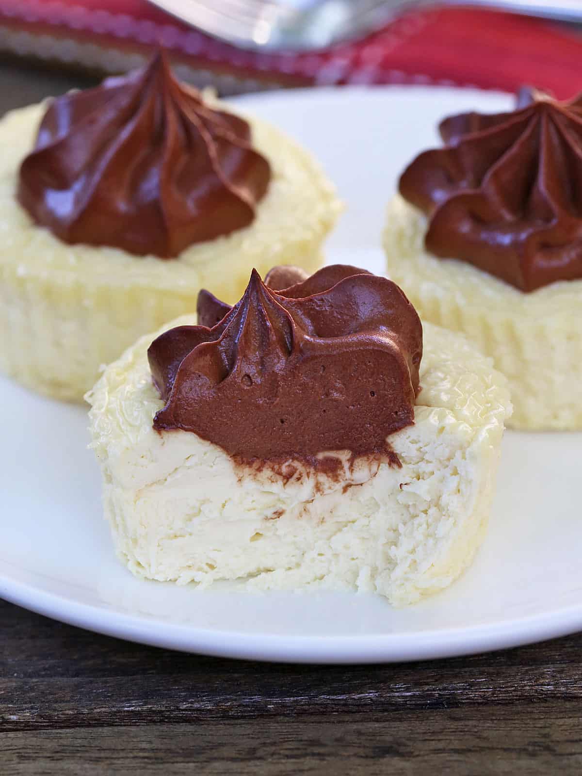 Keto mini cheesecakes are served on a white plate.
