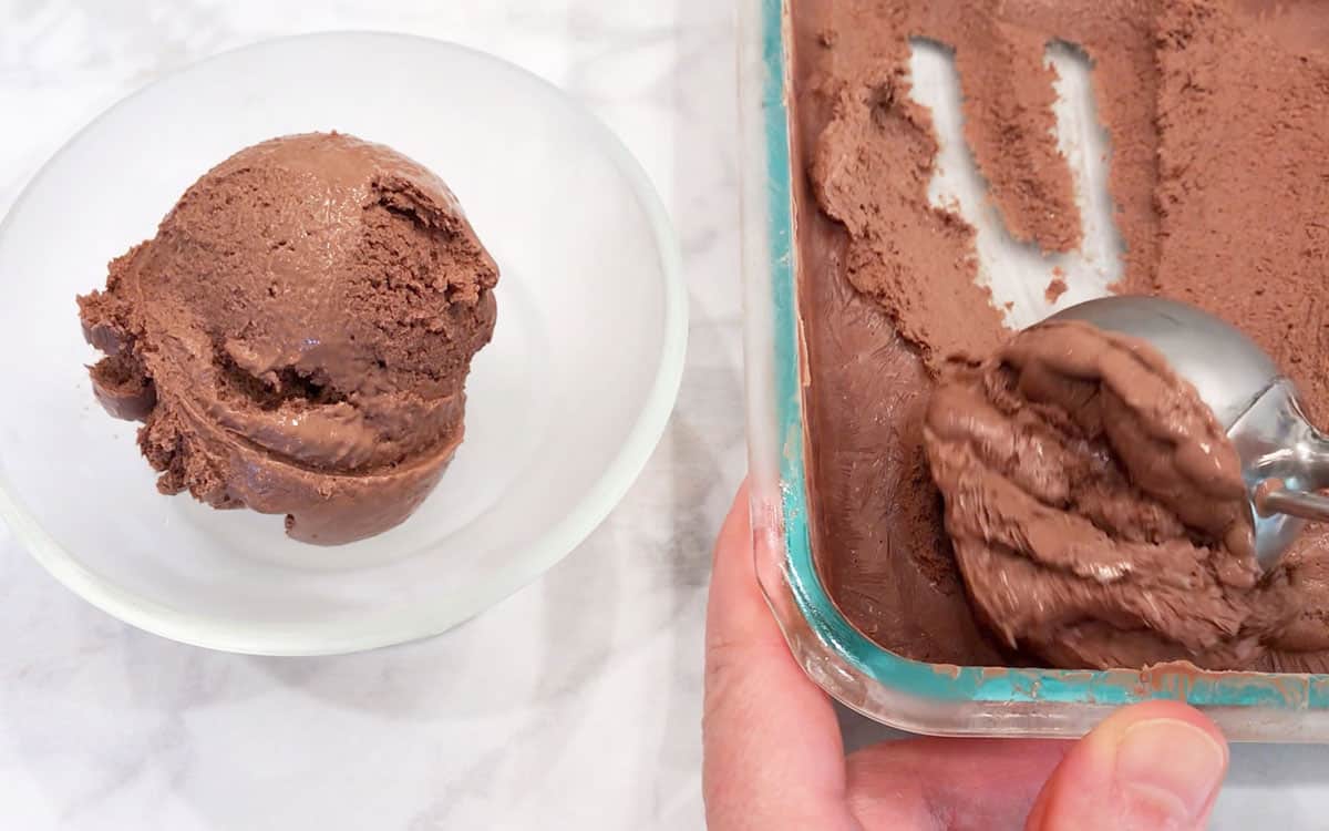Scooping the frozen yogurt into a dessert bowl.
