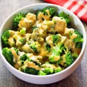 Broccoli and cheese is served in a white bowl.