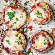 Keto eggplant parmesan on a parchment-lined baking sheet.