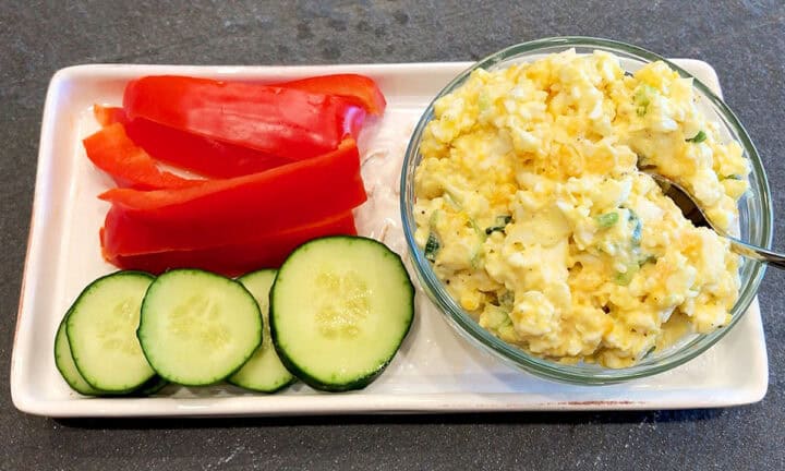 Keto egg salad is served with vegetables.